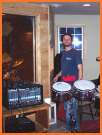 drummer Doug Knutsen loiters outside the isolation booth